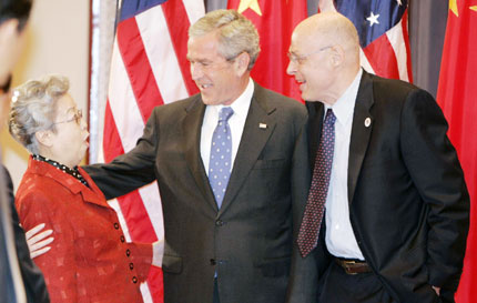 U.S. President George W. Bush (C) and U.S. Secretary of Treasury Henry Paulson (R) welcome Chinese Vice Premier Wu Yi to the Eisenhower Executive Office Building in the White House complex before a meeting of the U.S.-China Strategic Economic Dialogue in Washington, May 24, 2007.