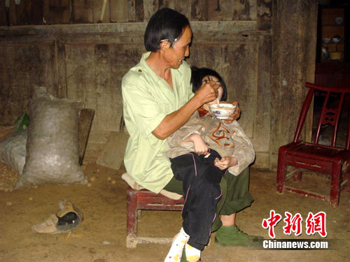 男子收養腦癱棄嬰20年 生活窘迫從未言棄(圖)