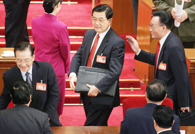 Chinese president Hu Jintao (C) ,Premier Wen Jiabao (L) and Chairman of the Standing Committee of China's National People's Congress Wu Bangguo (R) leave after the plenary session of National People's Congress at the Great Hall of the People in China's capital Beijing March 9, 2006.