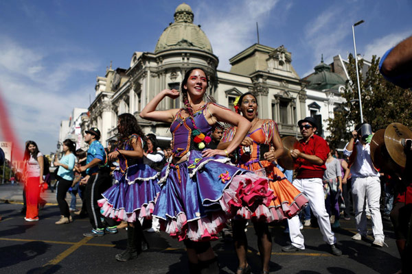 Participants in costume dance during a parade commemorating Earth Day in downtown Santiago, April 22, 2013. Earth Day marked around the world